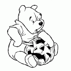 Pooh bear carves a Halloween pumpkin