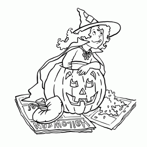 A young witch carving a pumpkin